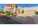 Two-story stucco condo with attached garage and landscaped front at 7800 E Lincoln Dr # 2004, Scottsdale, AZ 85250