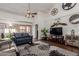 Living room with vaulted ceiling, hardwood floors, and large TV at 7800 E Lincoln Dr # 2004, Scottsdale, AZ 85250