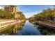 Scenic view of the canal with buildings in the background and palm trees along the river at 7800 E Lincoln Dr # 2004, Scottsdale, AZ 85250