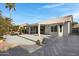 Spacious backyard with a herringbone-pattern patio and pond feature at 810 S Lagoon Dr, Gilbert, AZ 85233