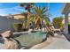 Stunning pool and spa surrounded by palm trees and rocks at 810 S Lagoon Dr, Gilbert, AZ 85233