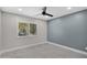 Spacious bedroom with gray tile floors and a ceiling fan at 810 S Lagoon Dr, Gilbert, AZ 85233