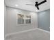 Bright bedroom with gray tile floors and a ceiling fan at 810 S Lagoon Dr, Gilbert, AZ 85233