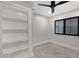 Bedroom with built-in shelving and ceiling fan at 810 S Lagoon Dr, Gilbert, AZ 85233