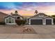 Two-story house with gray exterior, two-car garage, and landscaped yard at 810 S Lagoon Dr, Gilbert, AZ 85233