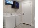 Laundry room with washer, dryer, and security system at 810 S Lagoon Dr, Gilbert, AZ 85233