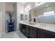 Elegant bathroom with double vanity, marble flooring and large shower at 10110 W Redbird Rd, Peoria, AZ 85383