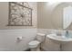 Elegant powder room with pedestal sink and wainscoting at 10110 W Redbird Rd, Peoria, AZ 85383