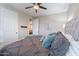 Bedroom with gray upholstered bed, teal blanket, and a dresser at 10110 W Redbird Rd, Peoria, AZ 85383