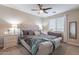 Bedroom with a gray upholstered bed frame and teal blanket at 10110 W Redbird Rd, Peoria, AZ 85383