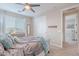 Bedroom with gray upholstered bed, teal blanket, and a dresser at 10110 W Redbird Rd, Peoria, AZ 85383