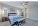 Bright bedroom with king bed, window seating, and ceiling fan at 10110 W Redbird Rd, Peoria, AZ 85383