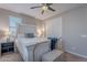 Bedroom with a white wooden bed frame, blue blanket and window blinds at 10110 W Redbird Rd, Peoria, AZ 85383