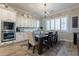 Bright dining room features a dark wood table and chandelier at 10110 W Redbird Rd, Peoria, AZ 85383