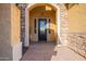 Inviting entryway with a stone facade and elegant iron door at 10110 W Redbird Rd, Peoria, AZ 85383