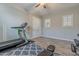 Bright home gym with a treadmill and weights at 10110 W Redbird Rd, Peoria, AZ 85383