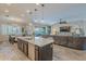 Island kitchen with granite countertops and stainless steel appliances at 10110 W Redbird Rd, Peoria, AZ 85383