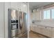 Stainless steel refrigerator in kitchen with white shaker cabinets at 10110 W Redbird Rd, Peoria, AZ 85383