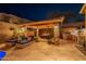 Elegant outdoor kitchen and lounge area with stone accents and comfortable seating at 10110 W Redbird Rd, Peoria, AZ 85383