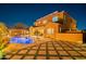 Gorgeous nighttime view of the pool and outdoor entertaining area at 10110 W Redbird Rd, Peoria, AZ 85383