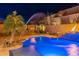 Luxury pool with fire pit and palm trees at 10110 W Redbird Rd, Peoria, AZ 85383