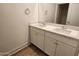 Bathroom boasts double sinks and modern white cabinets at 10150 E Thistle Ave, Mesa, AZ 85212