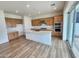 Modern kitchen with island, wood cabinets, and stainless steel appliances at 10150 E Thistle Ave, Mesa, AZ 85212