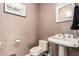 Clean bathroom with pedestal sink, toilet and mirror at 102 W El Caminito Dr, Phoenix, AZ 85021