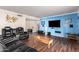 Living room with hardwood floors, blue accent wall, and seating at 102 W El Caminito Dr, Phoenix, AZ 85021