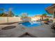 Relaxing kidney-shaped pool with surrounding patio and landscaping at 102 W El Caminito Dr, Phoenix, AZ 85021