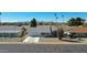 Single story home with gray roof, white exterior, and a view of mountains in the background at 10629 W Willow Creek Cir, Sun City, AZ 85373