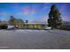 Backyard view showcasing gravel landscaping and a large tree at 10629 W Willow Creek Cir, Sun City, AZ 85373