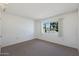 Simple bedroom with carpeted floors and a window at 10629 W Willow Creek Cir, Sun City, AZ 85373