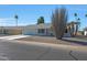 White single story home with gray roof, two car garage, and desert landscaping at 10629 W Willow Creek Cir, Sun City, AZ 85373