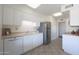 White kitchen with stainless steel appliances and dishwasher at 10629 W Willow Creek Cir, Sun City, AZ 85373