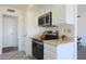 White kitchen with stainless steel appliances and view at 10629 W Willow Creek Cir, Sun City, AZ 85373