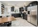 Updated kitchen with dark cabinetry, stainless steel appliances, and granite countertops at 10902 W Flanagan St, Avondale, AZ 85323