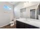 Clean bathroom with dark vanity, white countertop, and shower at 11225 E Marigold Ln, Florence, AZ 85132