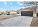 Recently built home with a two-car garage and neutral exterior at 11225 E Marigold Ln, Florence, AZ 85132