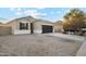 Charming one-story house with gray garage door and gravel driveway at 11225 E Marigold Ln, Florence, AZ 85132