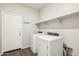 Laundry room with washer, dryer, and shelving at 11225 E Marigold Ln, Florence, AZ 85132