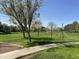 Expansive green space featuring mature trees and a walking path, perfect for recreation and enjoying the outdoors at 1161 S Storment Ln, Gilbert, AZ 85296