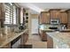 Modern kitchen with granite counters, ample cabinetry, and stainless steel appliances at 1161 S Storment Ln, Gilbert, AZ 85296