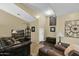 Living room featuring leather furniture and a large wall art piece at 1161 S Storment Ln, Gilbert, AZ 85296