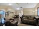 Spacious living room with leather seating and a wood dining table at 1161 S Storment Ln, Gilbert, AZ 85296