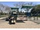 Community playground with shaded play structures and sand area, creating a safe and fun environment for  at 1161 S Storment Ln, Gilbert, AZ 85296