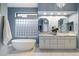 Elegant bathroom with double vanity, soaking tub, and large glass block window at 11748 N 80Th Pl, Scottsdale, AZ 85260