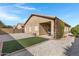 Landscaped backyard with artificial turf and covered patio at 1361 E Martha Dr, Casa Grande, AZ 85122