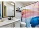 Clean bathroom with updated vanity and a colorful shower curtain at 14300 W Bell Rd # 480, Surprise, AZ 85374