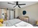 Bedroom with a barn door and ceiling fan at 14300 W Bell Rd # 480, Surprise, AZ 85374